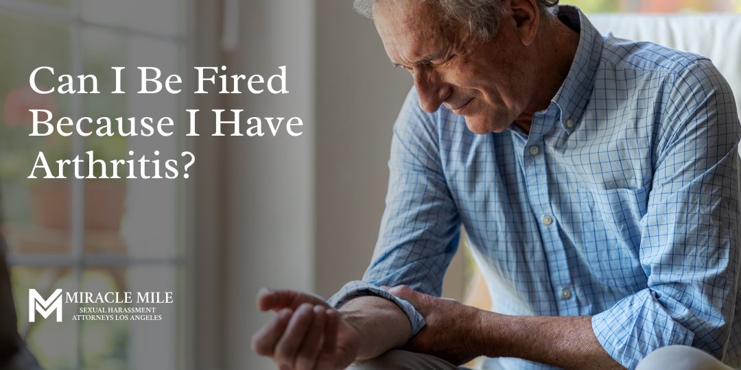 Can I Be Fired Because I Have Arthritis on top of a man holding forearm